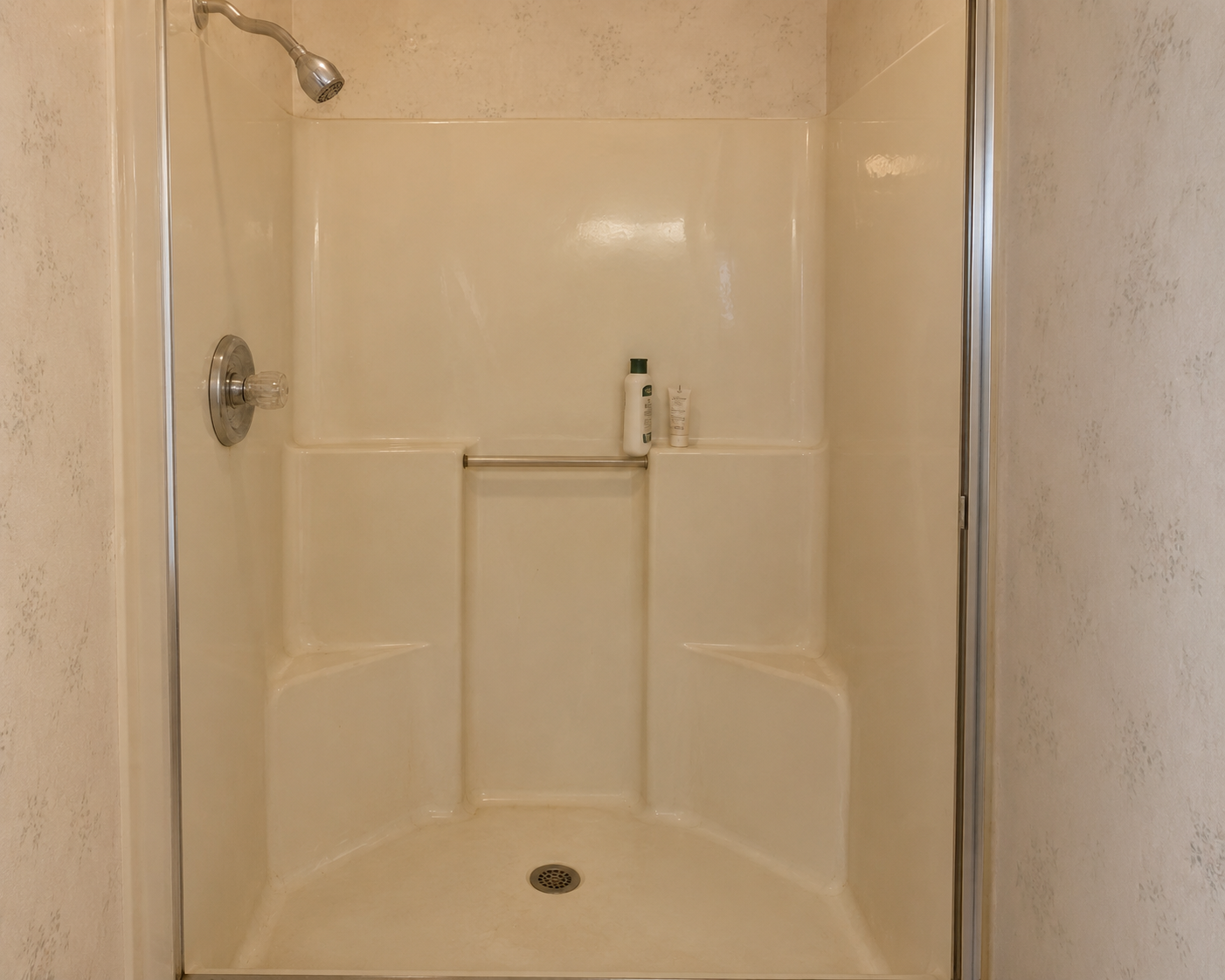 Outdated worn fiberglass shower stall in need of replacement